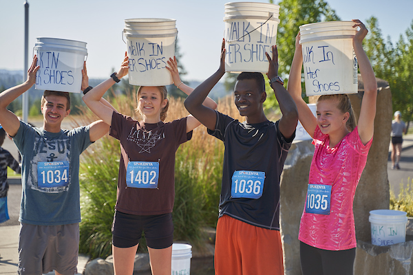 Group of 4 people posing for picture with buckets on their heads