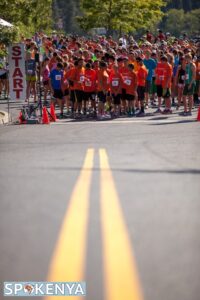 vertical photo of runners gathered at the start of the race